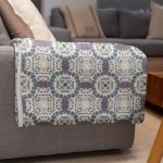 mockup of a throw blanket in a living room setting 24697 5